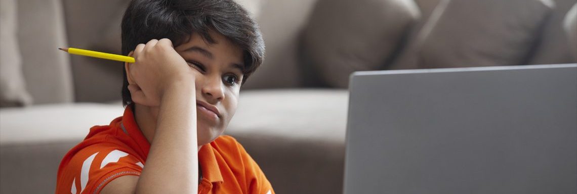 bored-boy-watching-laptop-computer-during-online-school-class